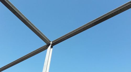 Low angle view of windmill against clear blue sky