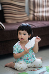 Cute baby girl sitting at home