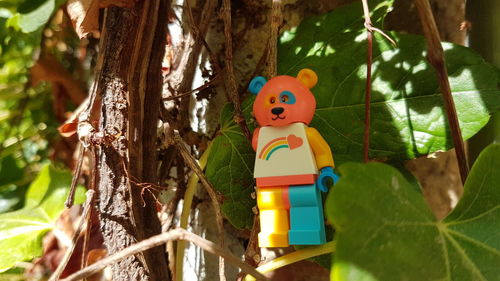 Close-up of toy on tree trunk