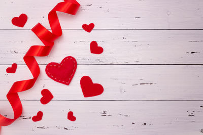 Close-up of heart shape on table against wall