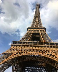 Low angle view of tower against cloudy sky