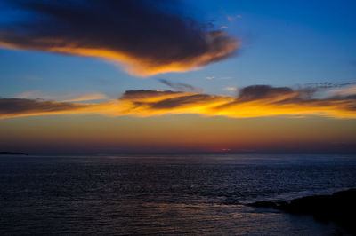 Scenic view of sea against romantic sky at sunset