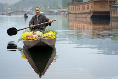 Man sitting in boat at lake