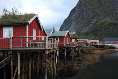 Houses by lake against sky