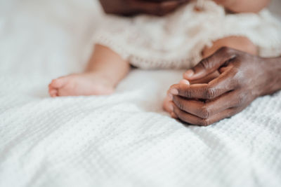 Close-up of baby lying on bed