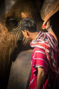 Young man with elephant in mouth