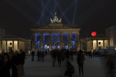 Group of people in illuminated building at night