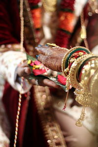 Close-up of human hand on cross