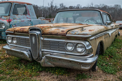 Abandoned car on field