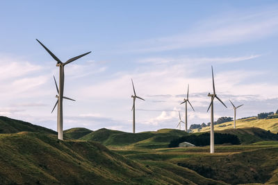 Windmill on field against sky