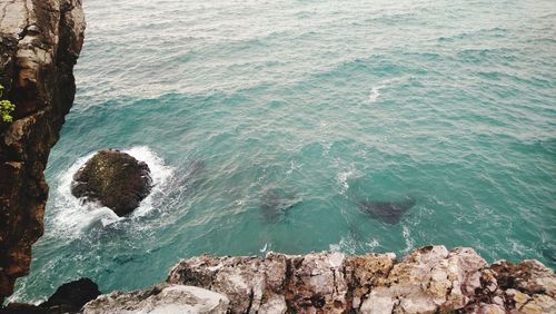 High angle view of rocks by sea