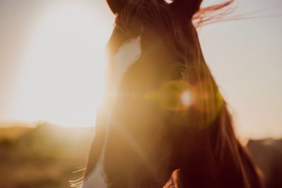 Close-up portrait of woman against sky