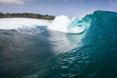 Close-up of waves in sea against sky