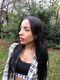 Portrait of beautiful young woman looking away