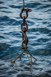 High angle view of chain hanging on water