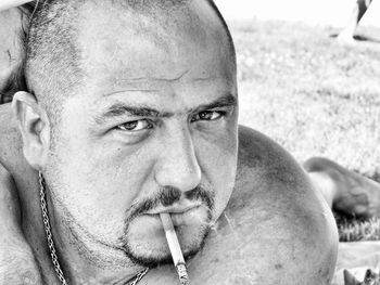 Close-up portrait of mature man smoking cigarette