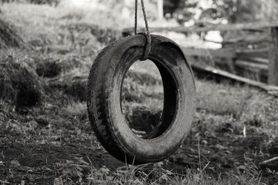 Close-up of abandoned wheel on field