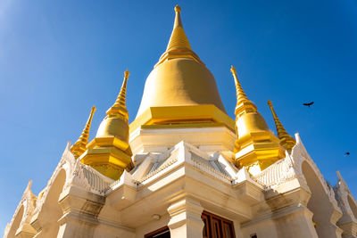 Low angle view of traditional building against clear blue sky