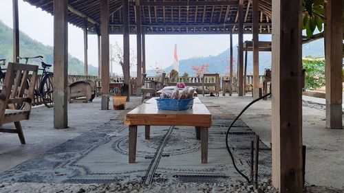 Chairs and tables in restaurant against sky