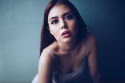 Portrait of beautiful woman against wall
