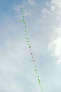 Low angle view of balloons against sky