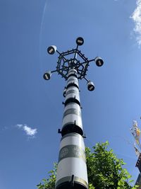 Low angle view of communications tower against sky