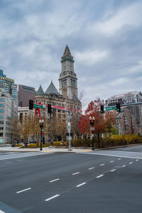 View of city buildings against cloudy sky