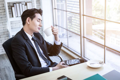 Rear view of man sitting at home