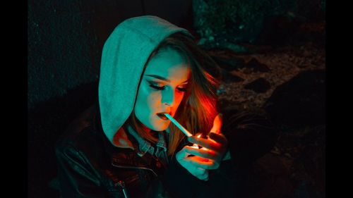 Close-up of young woman smoking