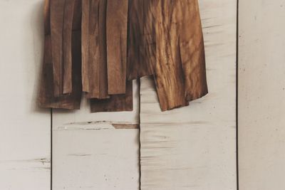 Close-up of fabric hanging against wooden wall