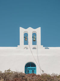 Low angle view of building against clear blue sky