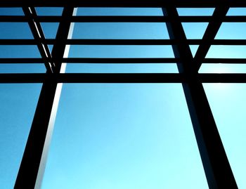 Low angle view of metallic structure against blue sky