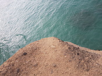 High angle view of rock by sea