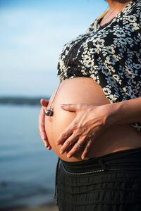 Midsection of woman with arms raised