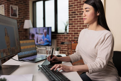 Young woman using laptop at office