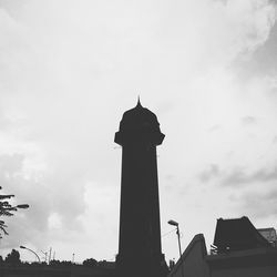 Low angle view of building against cloudy sky