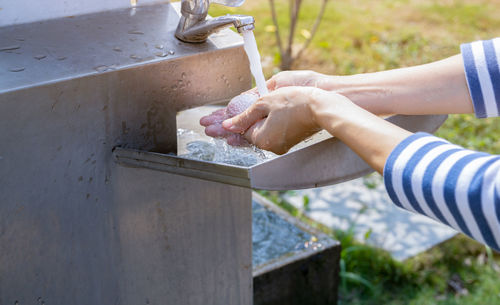 Cropped hand of person washing hands