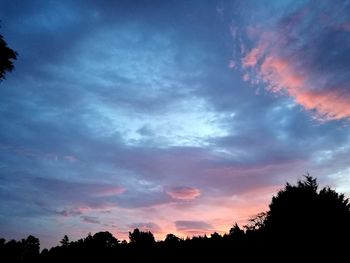 Silhouette trees against sky during sunset