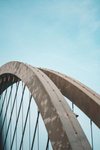 Low angle view of bridge against clear blue sky