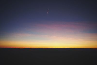 Scenic view of silhouette mountains against sky at sunset