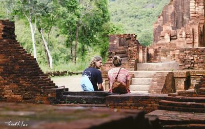 Tourists sitting on staircase