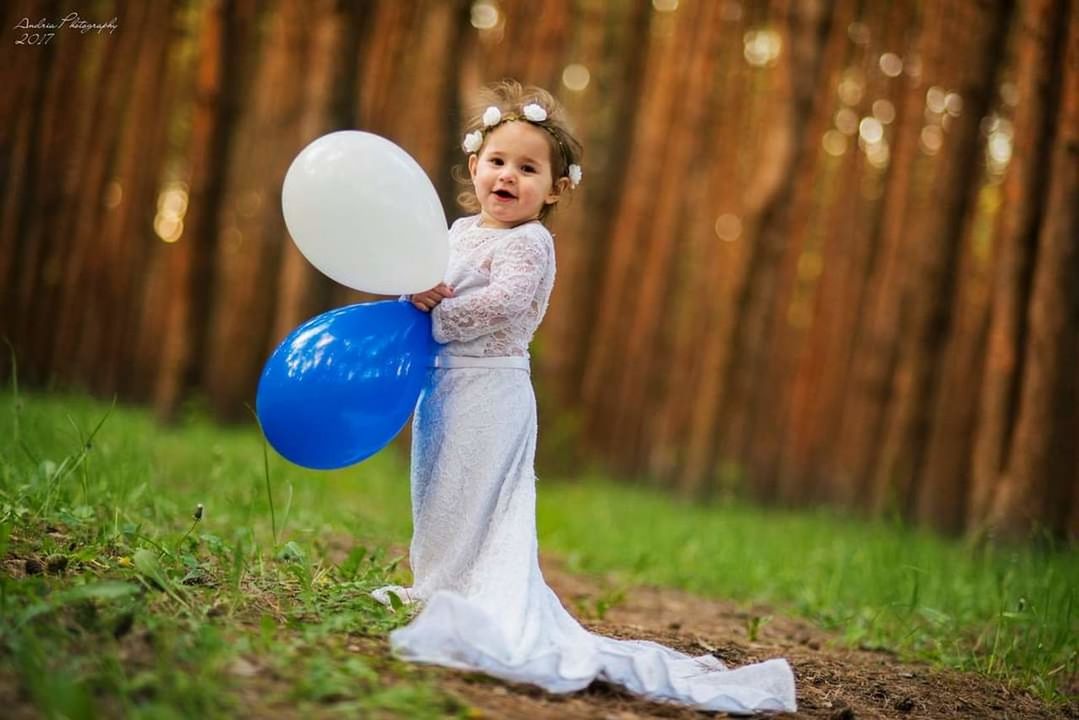 one person, plant, childhood, child, nature, balloon, women, full length, tree, grass, happiness, person, adult, female, clothing, land, smiling, emotion, fun, lifestyles, spring, outdoors, standing, blond hair, portrait, holding, forest, leisure activity, portrait photography, young adult, day, flower, green, ball, sports, positive emotion, cheerful, field