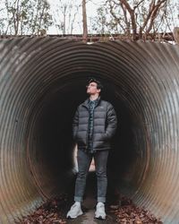 Man standing in tunnel during winter