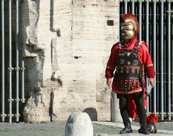 Portrait of man standing against wall