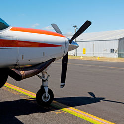 Airplane on airport runway against sky