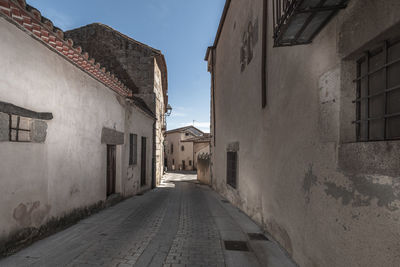 Street amidst buildings against sky