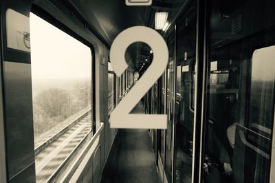 Close-up of number 2 on glass in train