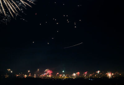 Low angle view of firework display at night