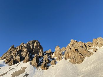 Scenic view of snowcapped mountains against clear blue sky