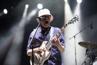 Man playing guitar at music concert